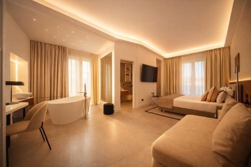 a large hotel room with a bed and a desk at Mamalu - Corso Umberto 35 - Studios and Suites in Naples