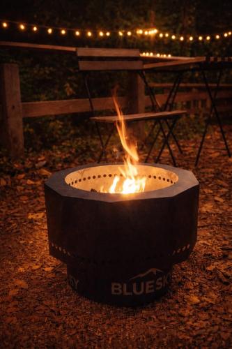 a fire pit in a yard with a table and lights at 川辺の宿-Kawabe-BBQ-川遊び in Hanno