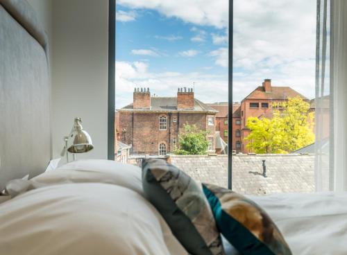 a bedroom with a view of a city from a window at Castle Chambers in York