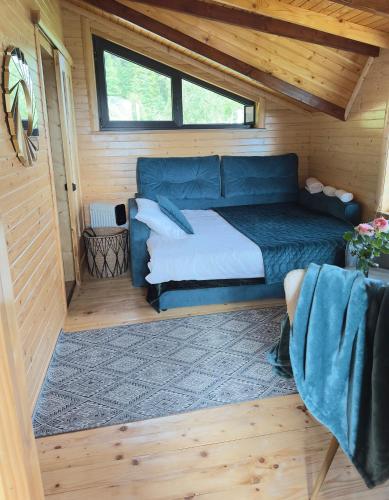 a bedroom with a bed in a wooden cabin at Гойра in Verkhniy Yasenov