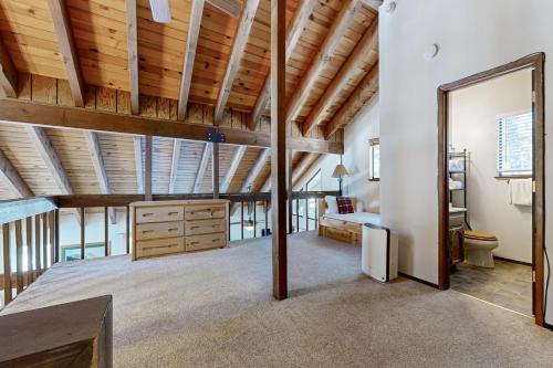 a large attic room with wooden ceilings and a large mirror at < 2 Mi to Tahoe Donner Ski Resort: Serene Retreat in Armstrong