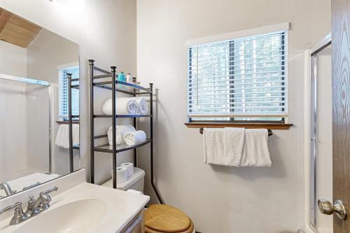 a bathroom with a sink and a toilet and a window at < 2 Mi to Tahoe Donner Ski Resort: Serene Retreat in Armstrong