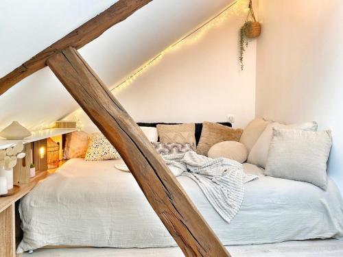 a room with a bed in the corner of a attic at Le Repères des sommeliers - Bail Partner in Auxerre