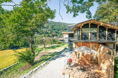 a house with a view of a road next to a house at CrossFit Otoyo Strength "TINY HOUSE" free Firepit, BBQ Grill, GYM in Otoyocho