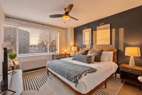 a bedroom with a large bed with a ceiling fan at CASA Arlington Suite with In-Suite Massage Chair & Premium Amenities in Arlington