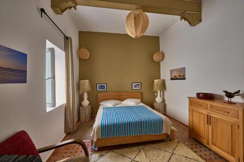a bedroom with a bed in a room at La Douiria Essaouira Medina in Essaouira
