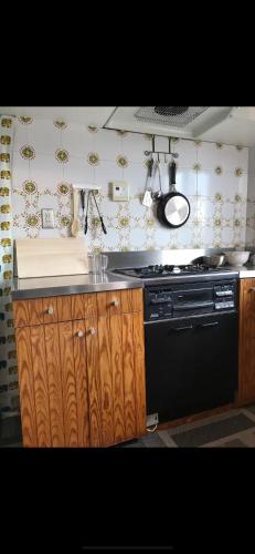 a kitchen with a stove and a counter top at Private Stay in Gotemba 縁 501 in Gotemba