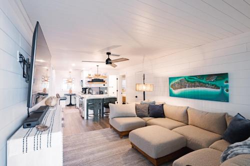 a living room with a couch and a table at Beachfront Corner Condo With Sunset Gulf Views in Bradenton Beach