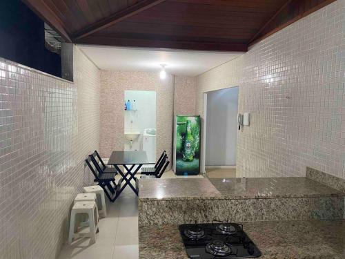 a kitchen with a stove and a counter top at Duplex 3 quartos 5 min da UFV in Viçosa