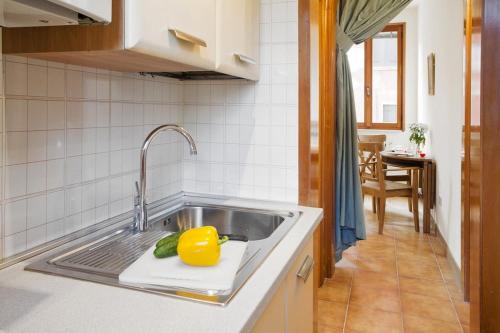 a kitchen with a sink with a yellow lemon on it at Locappart Redentore in Venice