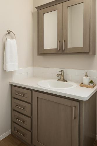 a bathroom with a sink and a mirror at Marina View Cottage at Key Largo in Key Largo