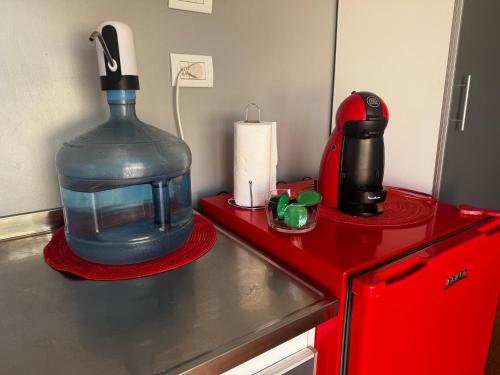 a kitchen counter with a large water bottle sitting on a counter top at KooColand- Container con jacuzzi privado in Tupungato