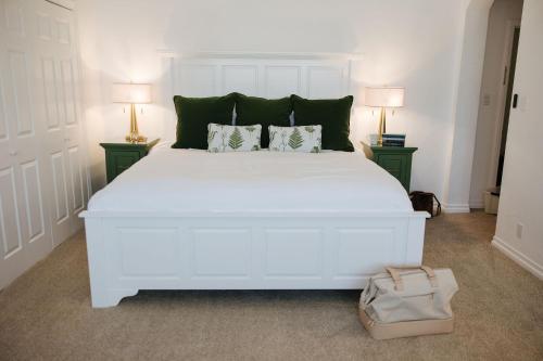 a white bed with two night stands and two lamps at The Sovereign in Los Angeles