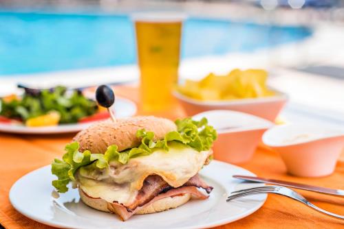 a sandwich and french fries on a plate at Sao Felix Hotel Hillside & Nature in Póvoa de Varzim