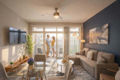 a man and a woman standing in a living room at Modern 2BD DT - Balcony, Gym, W-D, Parking - Sleeps 8 in Phoenix