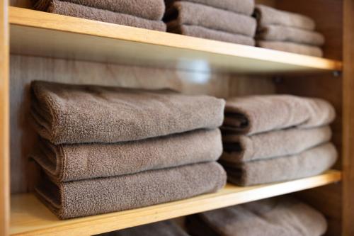 a bunch of towels are sitting on a shelf at Ocean Terrace金武 in Kin