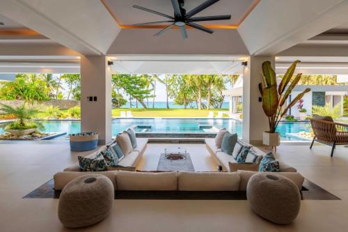 a living room with a couch and a pool at Luxury villa with Private beach access in Sosúa