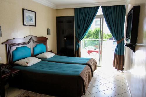 Postel nebo postele na pokoji v ubytování New Farah Hotel