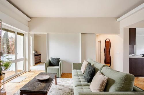 a living room with a couch and a table at OLIVA 50 - 4 Bedrooms and Office - 3 Bathrooms - Near Lisbon Expo & Airport in Lisbon