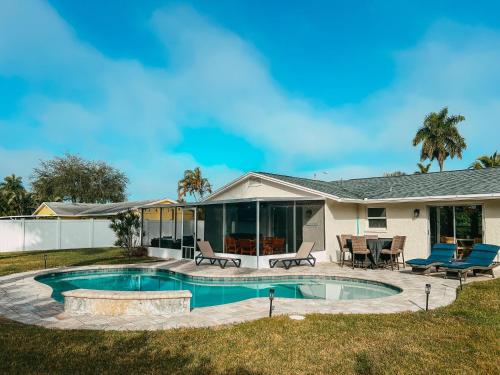 a house with a swimming pool in the yard at Pool Home Near Downtown, 5th Ave, Beaches & Pier in Naples
