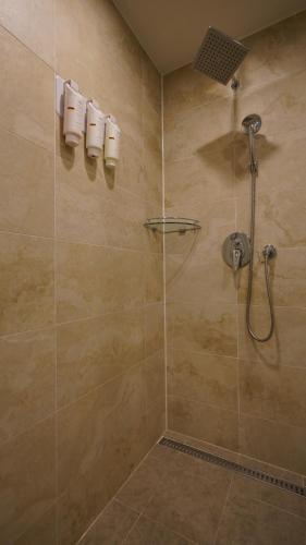 a shower with a glass door in a bathroom at Gloucester Hotel Jeonju in Jeonju