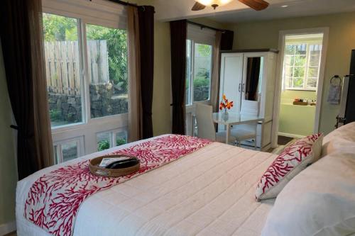 a bedroom with a large bed with a basket on it at Kona Nook - Cozy Studio with Island Warmth in Kailua-Kona