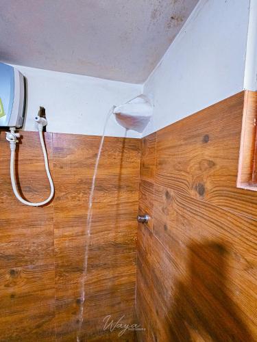 a bathroom with a hose coming out of a ceiling at Elephant paradise Safari lodge in Udawalawe