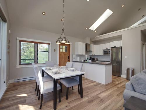 a kitchen and dining room with a table and chairs at Oceanfront & Amazing Views - Pet Friendly - 2bdrm in Port Renfrew