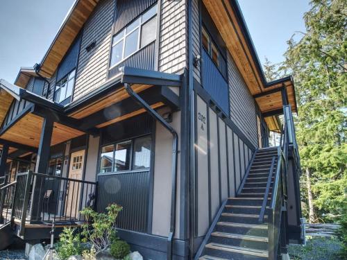 a house with stairs leading up to the front of it at Oceanfront & Amazing Views - Pet Friendly - 2bdrm in Port Renfrew