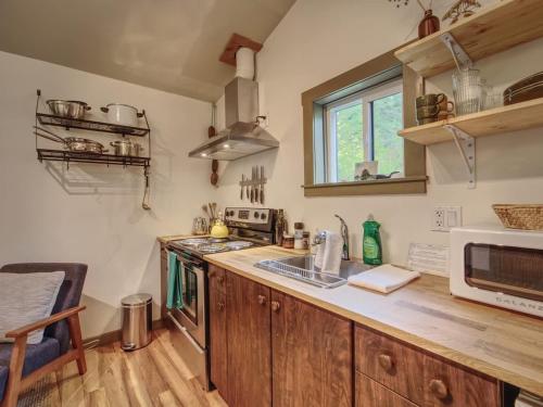 a kitchen with a counter top and a microwave at The Rocky Knoll - Garden View - Pet Friendly in Port Renfrew