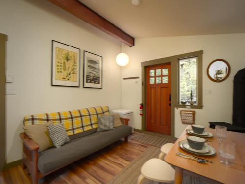 a living room with a couch and a table at The Rocky Knoll - Garden View - Pet Friendly in Port Renfrew