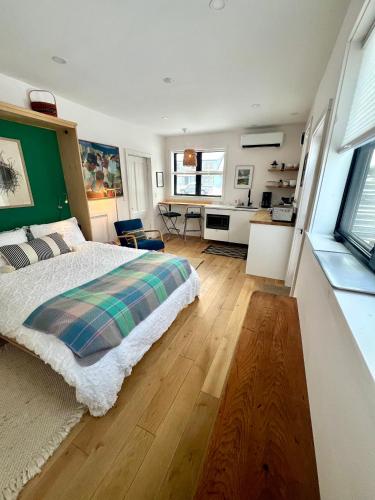 a bedroom with a bed and a room with a desk at Maine Mountain Retreat in Bethel
