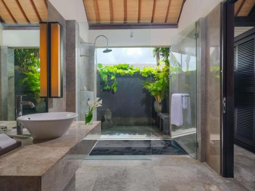 a bathroom with a tub and a sink at Peppers Seminyak in Seminyak