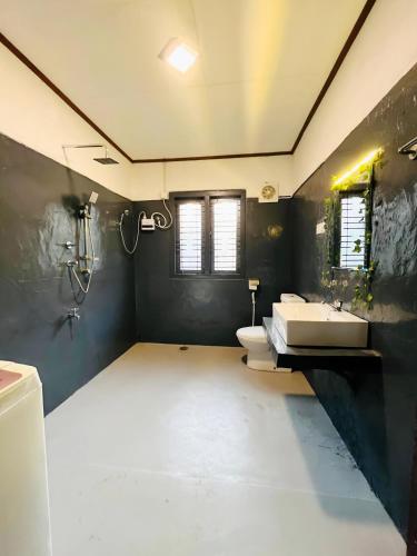 a bathroom with two sinks and two toilets at Windy Oasis in Hikkaduwa