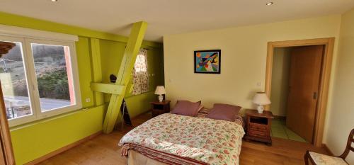 a bedroom with a bed and a window at La Ferme des Cherrieres - Piscine Intérieure Chauffée in Rupt-sur-Moselle
