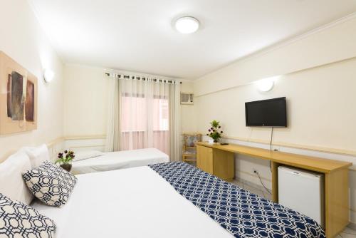 Una cama o camas en una habitación de Hotel Guarany