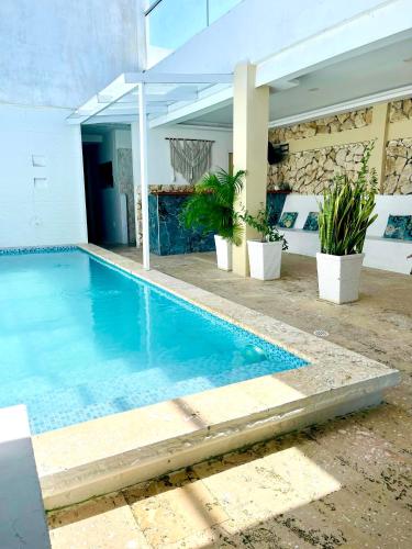 a swimming pool in the middle of a house at Open Sea Hotel Cartagena - Frente al mar in Cartagena de Indias