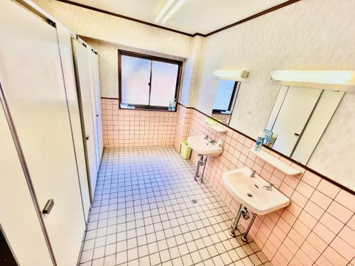 a bathroom with two sinks and two mirrors at 神庭-kaniwa- in Chichibu