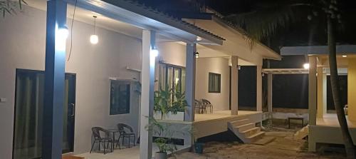 a house with chairs and a porch at night at Jeab Villa Kohphangan in Ko Phangan