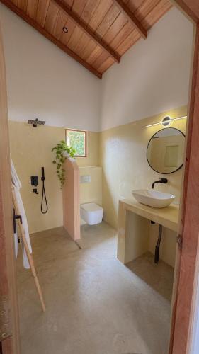 a bathroom with a sink and a toilet at Villa Palm in Rekawa