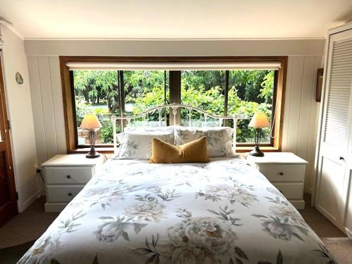 a bedroom with a bed and a large window at McIvor Lodge in Invercargill