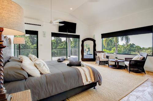a bedroom with a large bed and a living room at Tranquility Retreat in Mission Beach