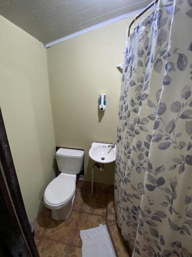 a bathroom with a toilet and a sink at Tropical Quiet Retreat in Venecia