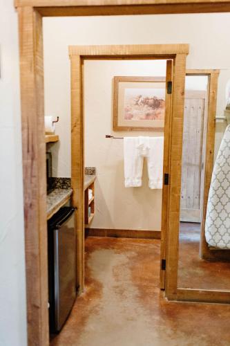 an open door to a kitchen with towels hanging on the wall at Wildcatter Ranch and Resort in Graham