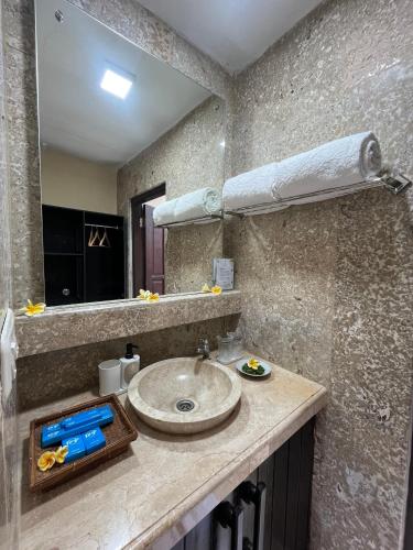 a bathroom with a sink and a mirror at Domisili Ijen Cliff By Fays Hospitality in Banyuwangi