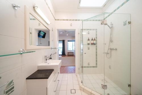 a bathroom with a shower and a sink at Tranquility Retreat in Mission Beach