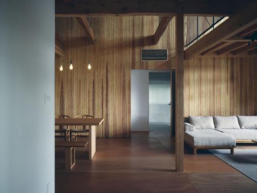 a living room with a couch and a table at SANU 2nd Home MON Amami Oshima in Tatsugo