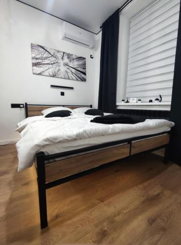 a bedroom with a large bed with a window at Smart Loft Studio Center Walking street in Chişinău
