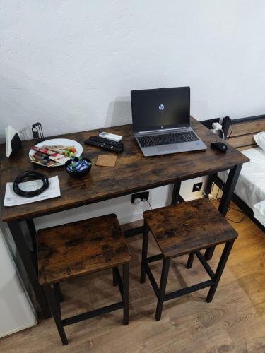 a wooden desk with a laptop computer on it at Smart Loft Studio Center Walking street in Chişinău
