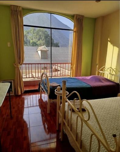 a bedroom with a bed and a large window at Large quiet apartment in condominium in Santa Eulalia